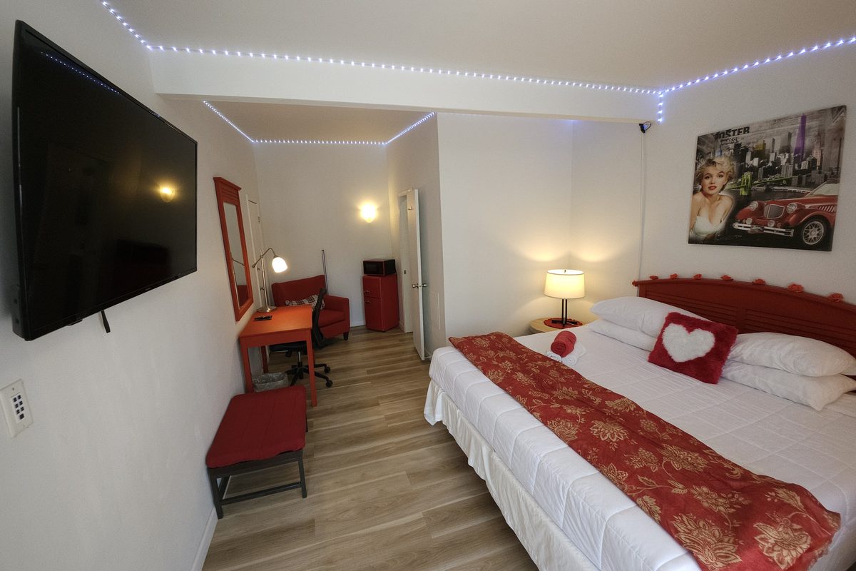 Romance suite at Blazers Lodge with mood lighting, a king bed and accent decor
